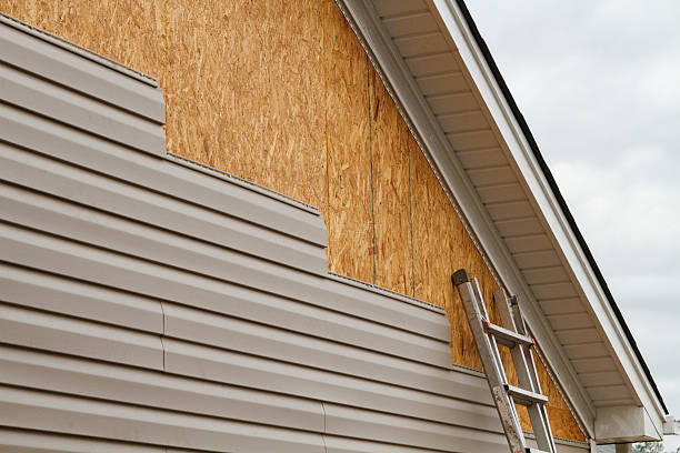 Professional Storm Damage Siding Repair technician working in Dover, OH